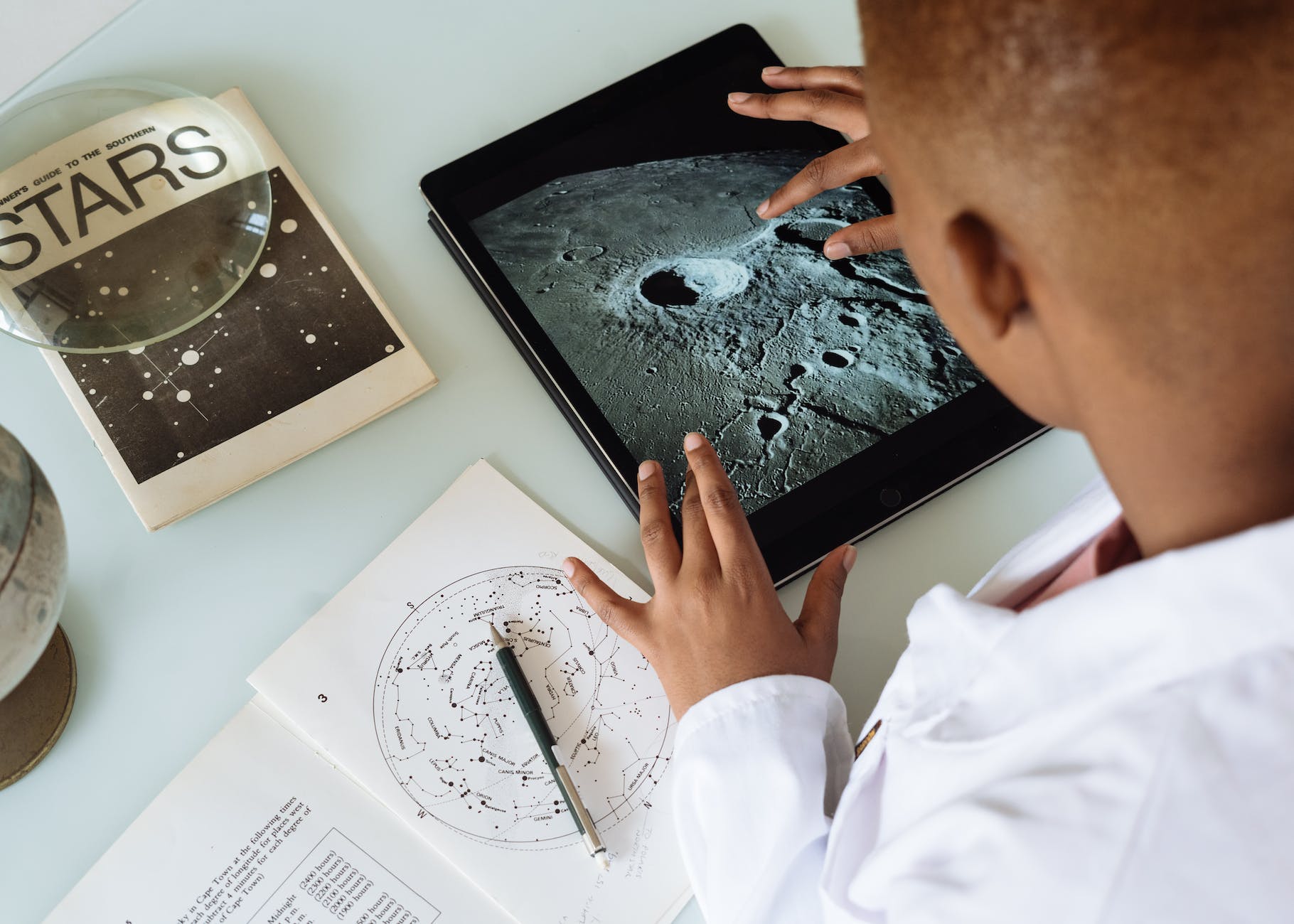 crop african american student studying craters of moon on tablet at observatory. Why is love for learning important?