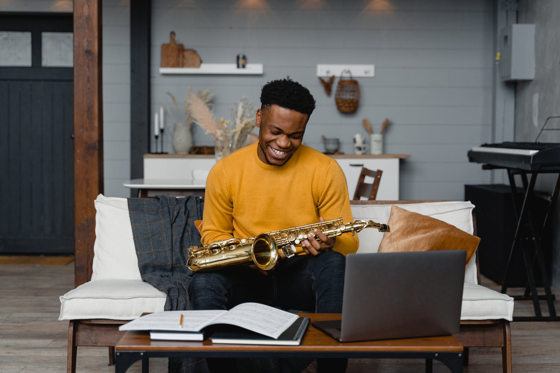 man in yellow long sleeve shirt holding a saxophone. What is love for learning?