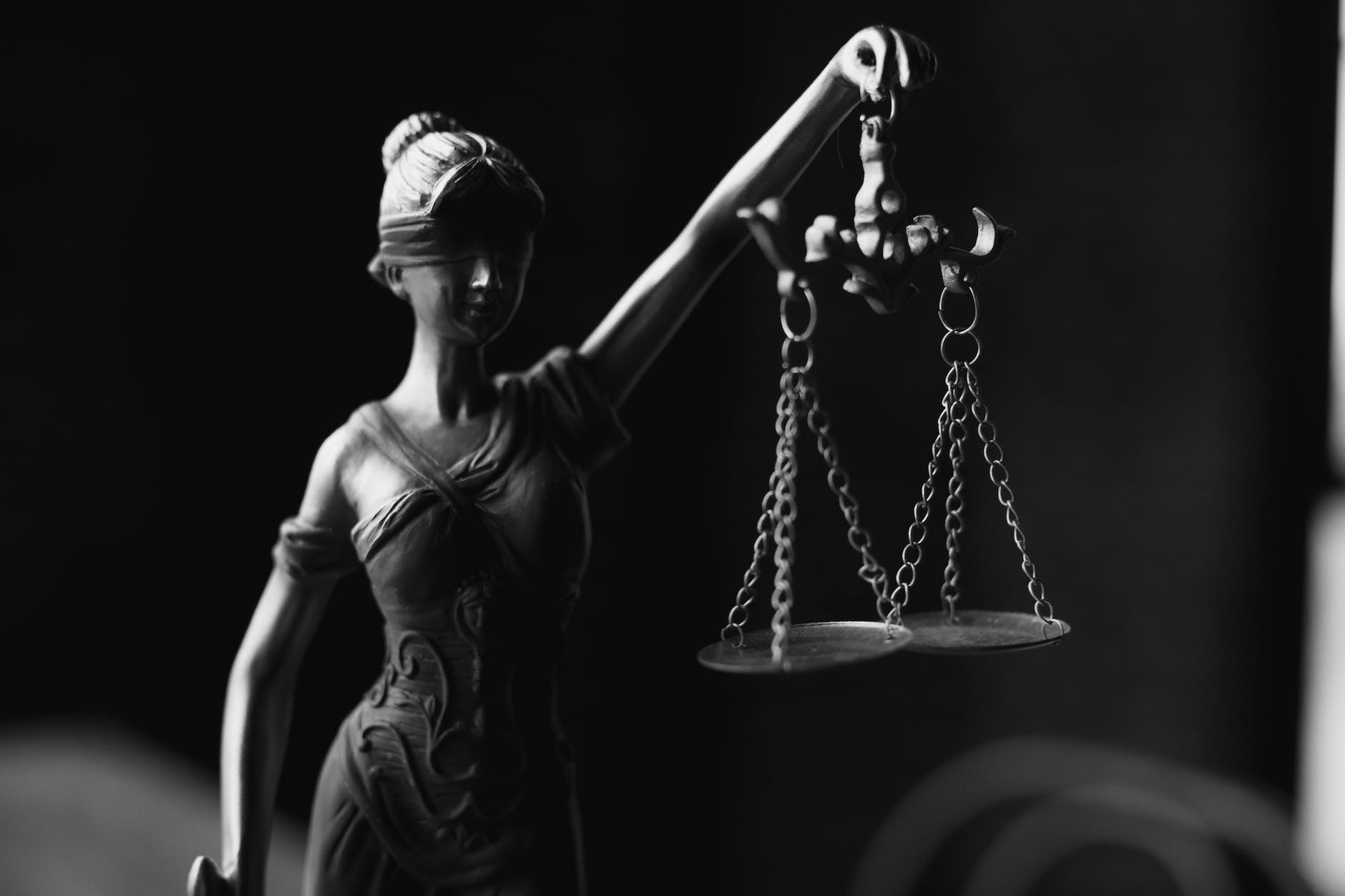 a grayscale of a lady justice figurine

What does it mean to be fair?
